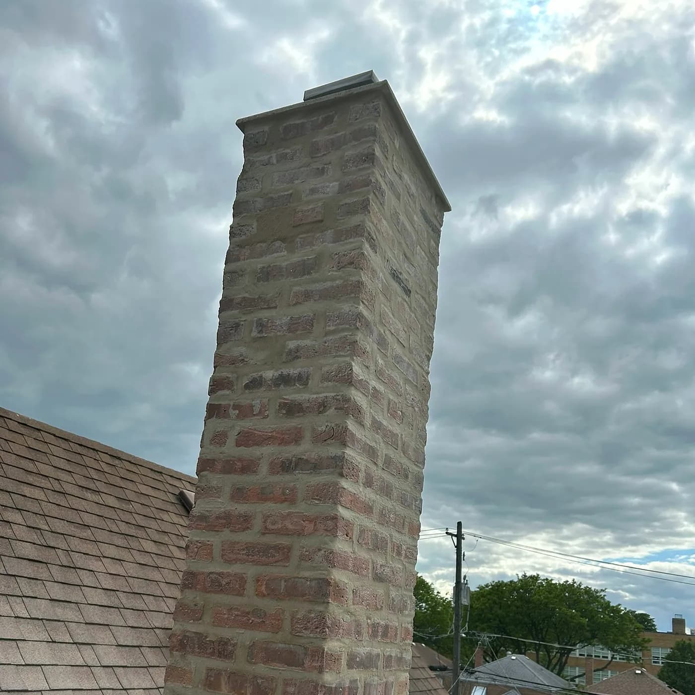 Chimney rebuilt from the roofline up with new crown and flashing