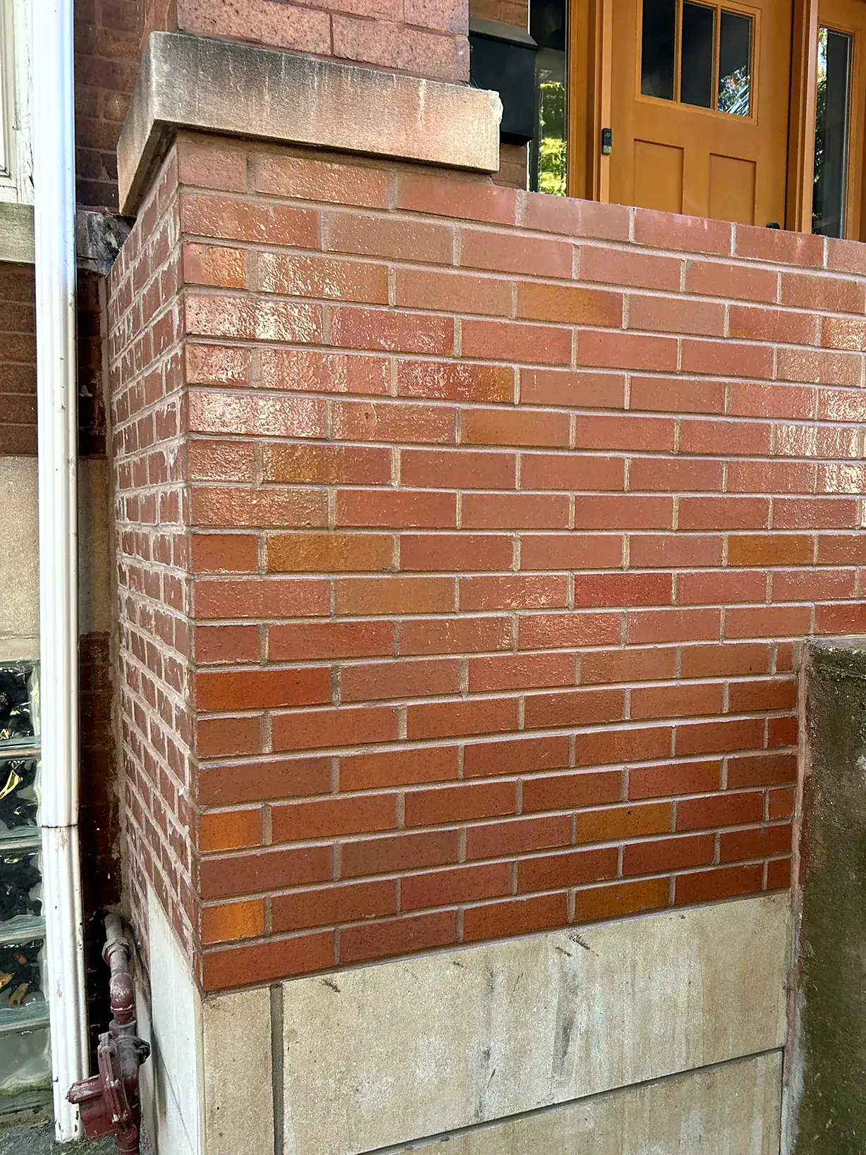 Brick and limestone entry stoop rebuilt with fresh mortar joints