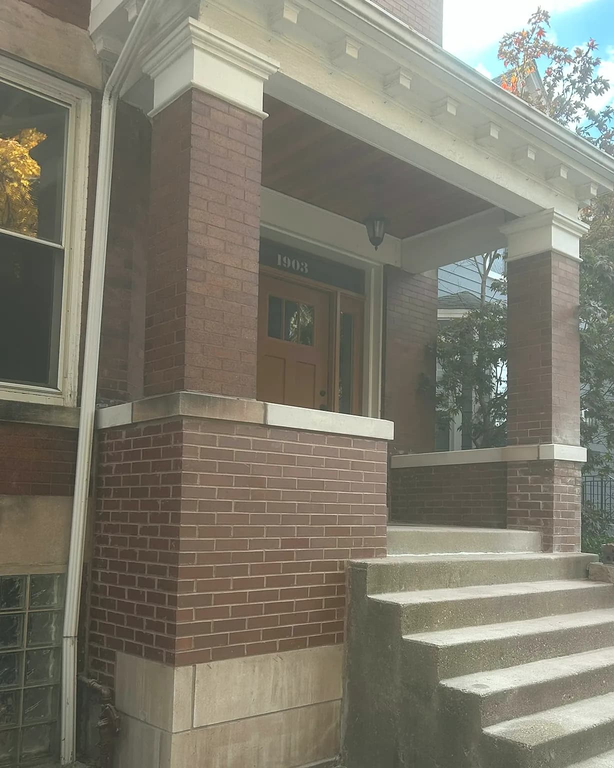 Brick porch pillars and limestone caps rebuilt on a Chicago greystone