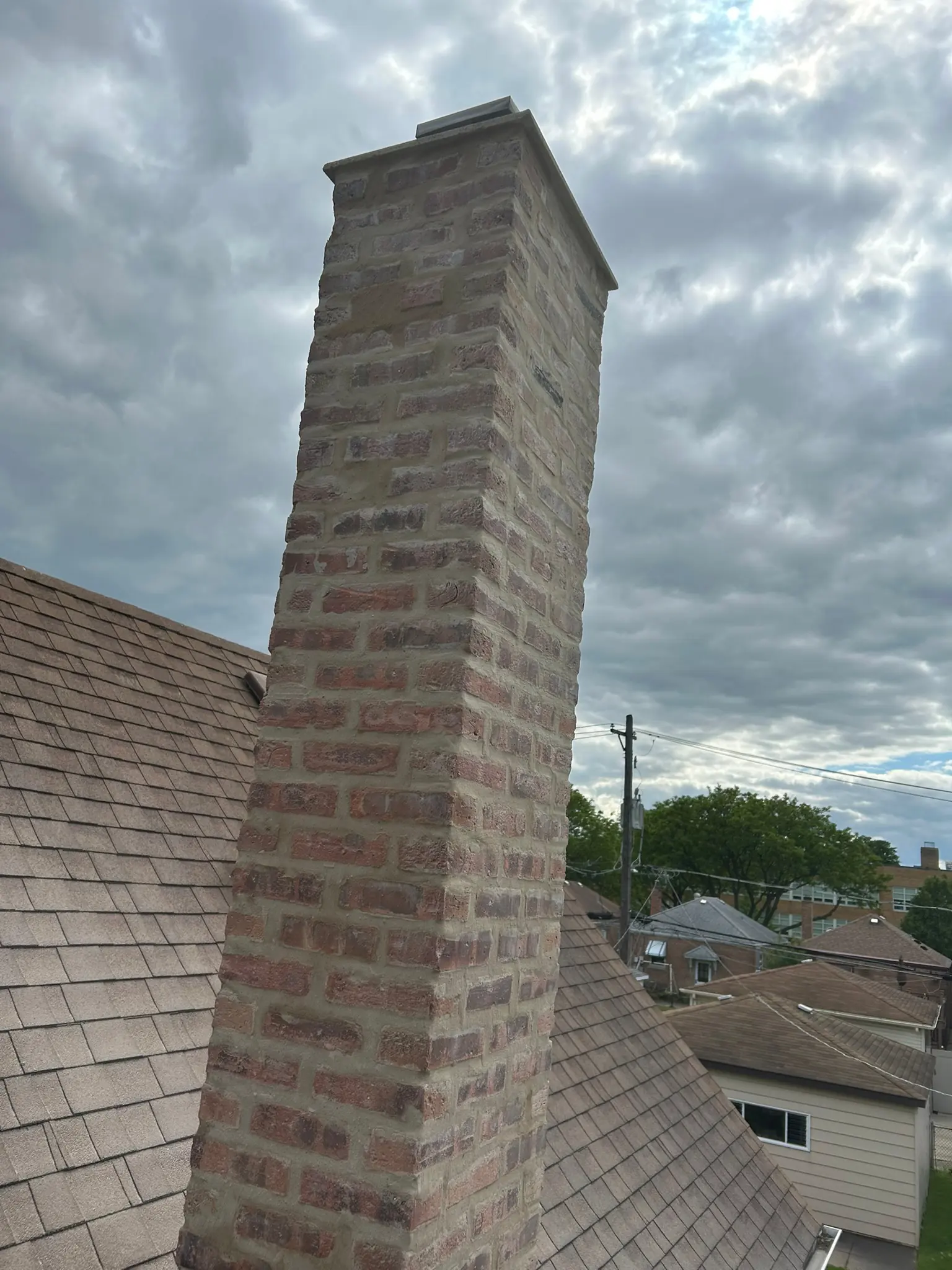 Why Brick Chimneys Lean or Pull Away From the House — Causes, Risk, and Repair