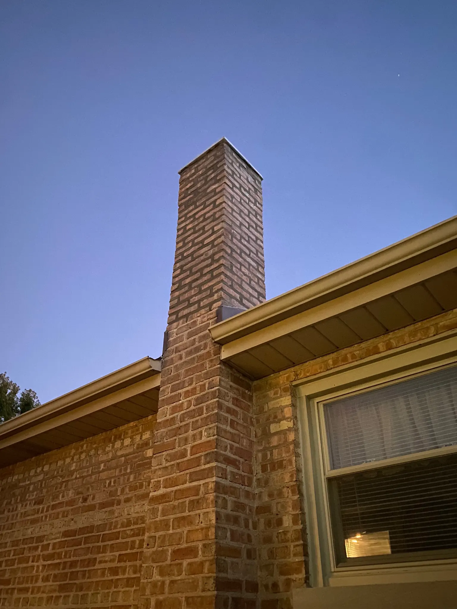 Repaired brick chimney with new crown and cap on a home in Batavia Illinois